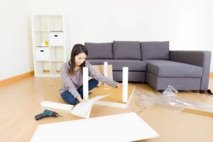 Woman assembling flat-pack furniture in a modern living room