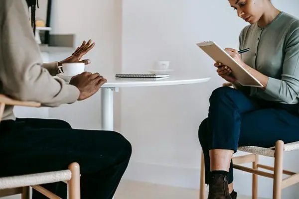 Therapist and patient having a focused conversation during a mental health evaluation session